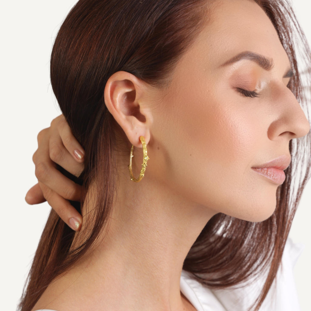 an image of a model wears Medium Golden Twig Hoop Earrings from Beyond Bling Jewellery website