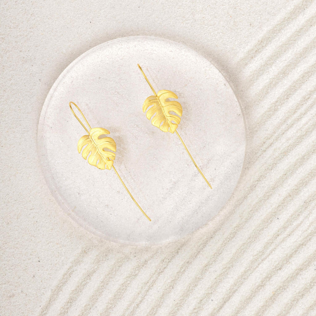 Monstera Leaf Gold Drop Earrings on sand
