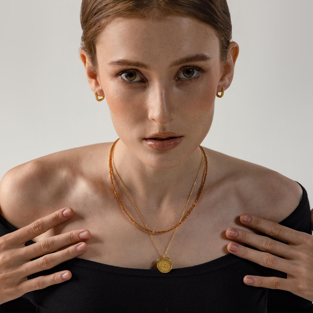 a photo of a model wears Ancient Greek Round Pendant Necklace from Beyond Bling Jewellery