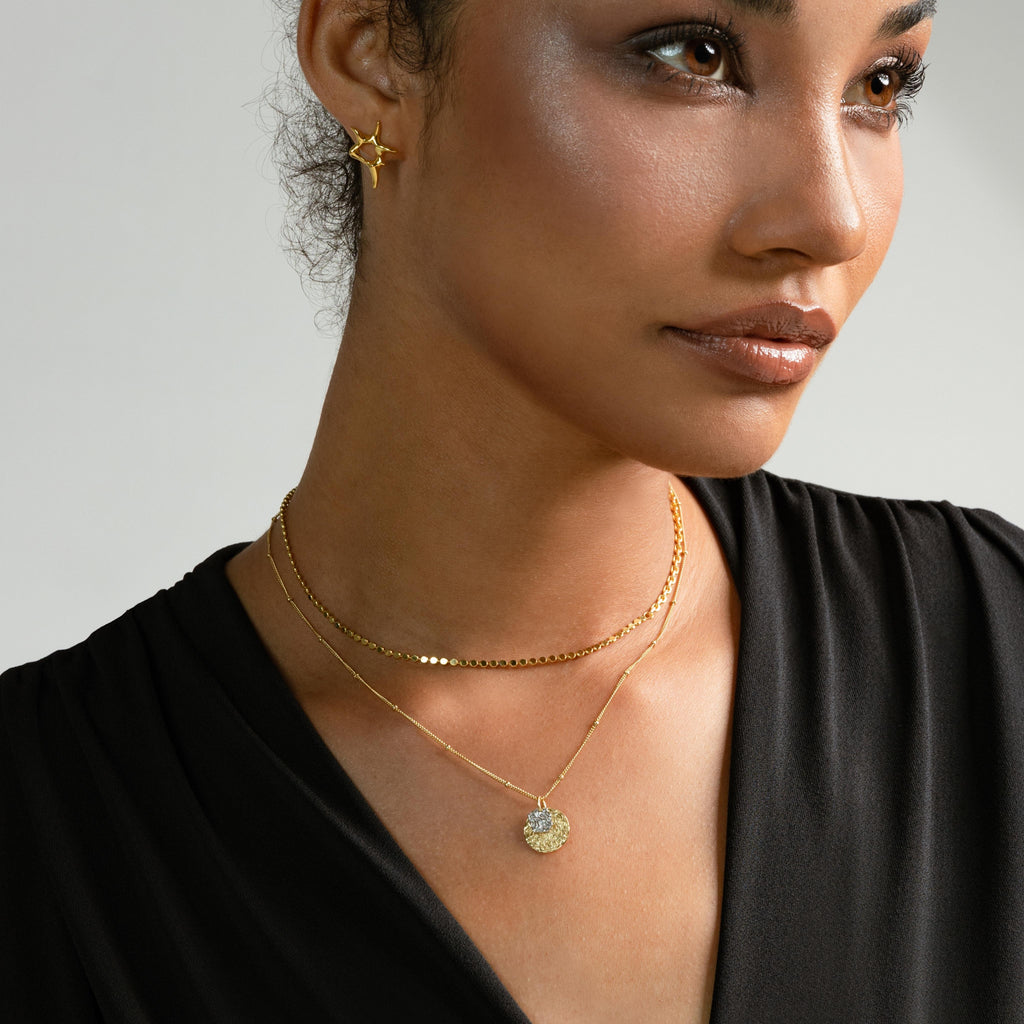 a photo of a model wears Embossed Antique Double Coins Necklace from beyond bling jewellery