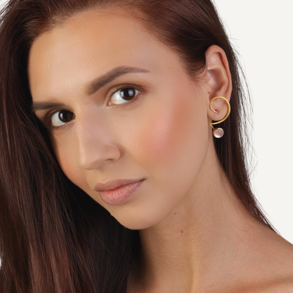 an image of a model wears Crystal Curved Gold Statement Earrings frpm Beyond Bling Jewellery website