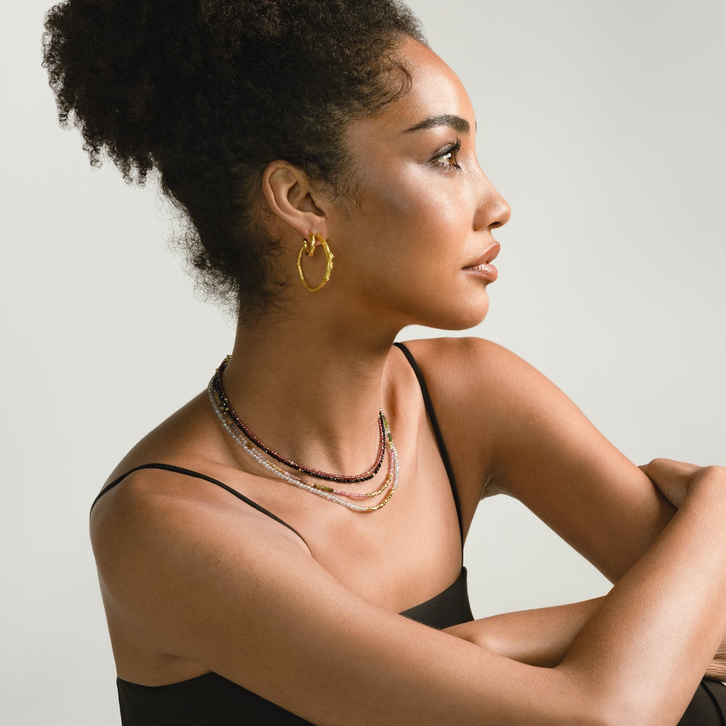 a photo of a model wears Golden Twig Hoop Earrings from Beyond Bling Jewellery