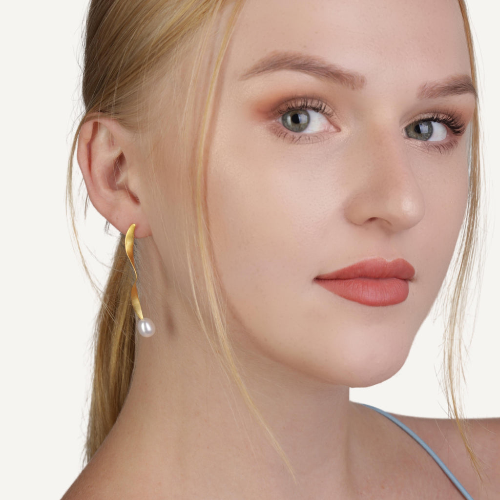 a photo of a model wears Twisted Gold Drop Earrings from Beyond Bling Jewellery website