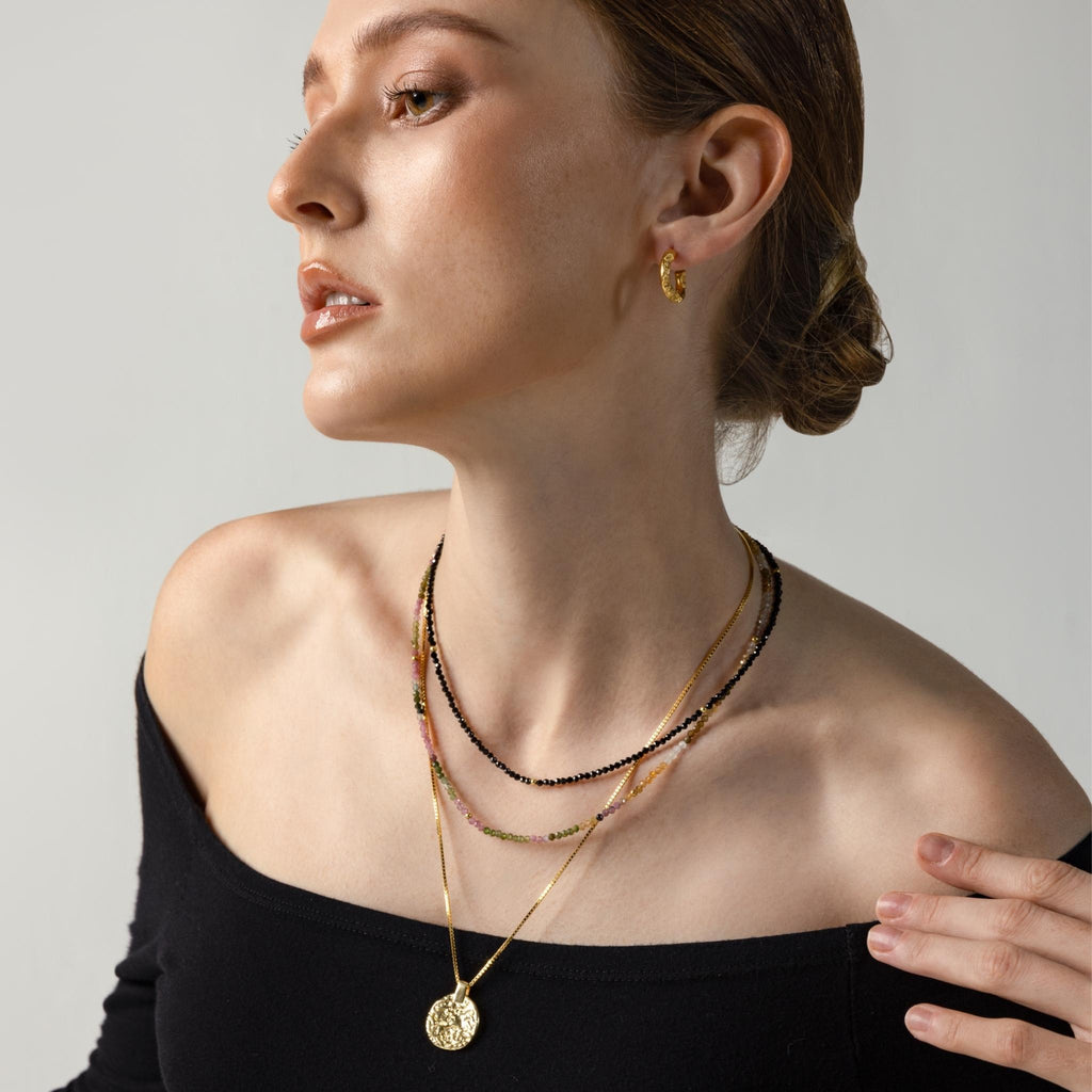 a photo of a model wears Engraved Double Sided Coin Necklace from Beyond Bling Jewellery