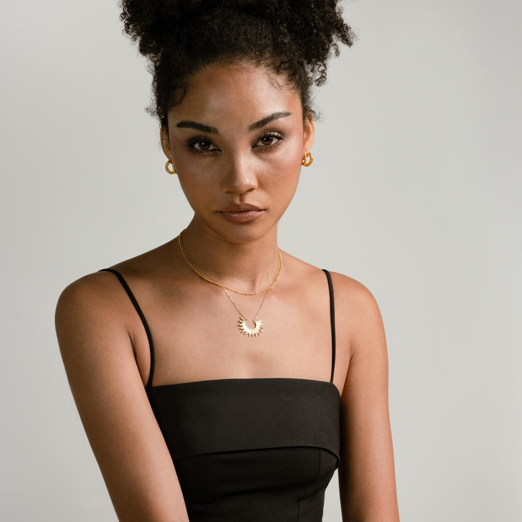 a photo of a model wears Exaggerated Sunlight Pendant Necklace from Beyond bling jewellery