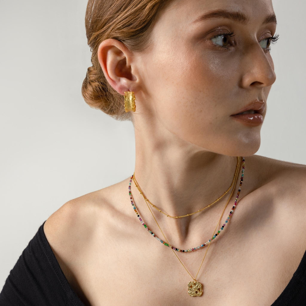 a photo of a model wears Irregular Rock Face Pendant Necklace from Beyond Bling Jewellery