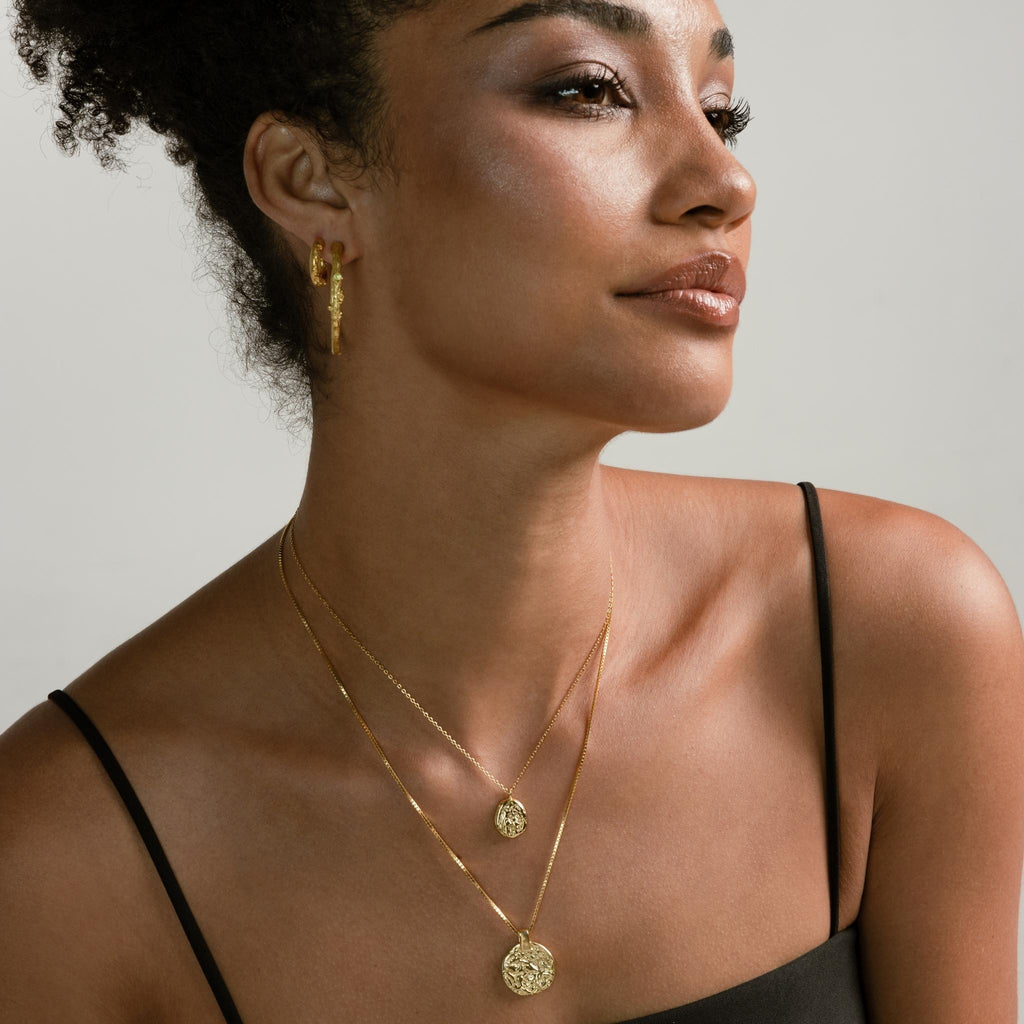 a photo of a model wears Lava Texture Pendant Necklace from beyond bling jewellery