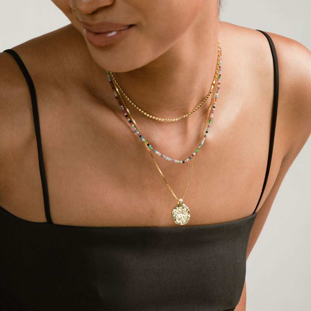 a photo of a model wears Natural Rainbow Round Faceted Gemstones Beaded Necklace on beyond bling jewellery website